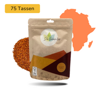 Der Geheimtipp Morgenrot Tee Verpackung aus Papier mit losem Bio Rooibos Tee im Hintergrund