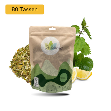 Der Geheimtipp Gipfelstürmer Tee Verpackung aus Papier mit losem Zitrone Brennnessel Minze Kräutertee im Hintergrund