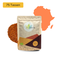 Der Geheimtipp Morgenrot Tee Verpackung aus Papier mit losem Bio Rooibos Tee im Hintergrund