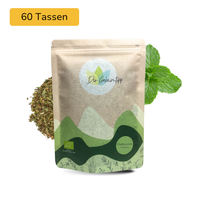 Der Geheimtipp Pfefferminze Tee Verpackung aus Papier mit losem Pfefferminze Kräutertee im Hintergrund