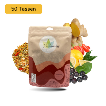 Der Geheimtipp Superfruit Tee Verpackung aus Papier mit losem Zitrone Gojibeere Aroniabeere Früchtetee im Hintergrund