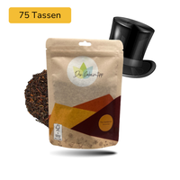 Der Geheimtipp The Gentleman Tee Verpackung aus Papier mit losem Darjeeling Schwarztee im Hintergrund